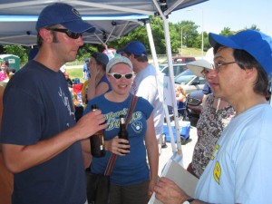 Craig Nickels and wife Diana Schoberg chat with Chris Foran at the newsroom tailgate at Miller Park.